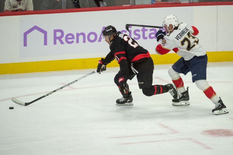 Nov 27 2023; Ottawa, Ontario, CAN; Ottawa Senators right wing Mathieu Joseph (21) skates with the puck in front of Florida Panthers center Carter Verhaeghe (23) in the third period at the Canadian Tire Centre. Mandatory Credit: Marc DesRosiers-USA TODAY Sports