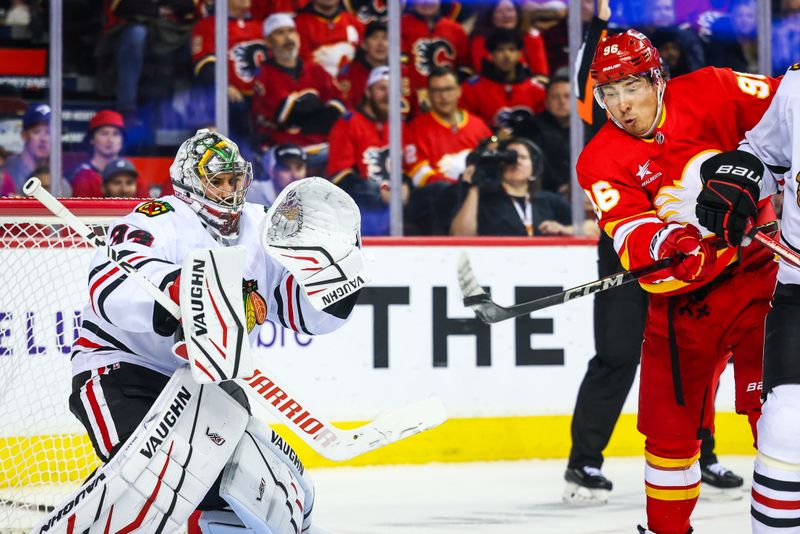 Oct 15, 2024; Calgary, Alberta, CAN; Calgary Flames left wing Andrei Kuzmenko (96) scores a goal against Chicago Blackhawks goaltender Petr Mrazek (34) during the second period at Scotiabank Saddledome. Mandatory Credit: Sergei Belski-Imagn Images