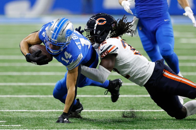 Detroit Lions wide receiver Amon-Ra St. Brown (14) is tackled by Chicago Bears cornerback Terell Smith (32) during the second half of an NFL football game in Detroit, Thursday, Nov. 28, 2024. (AP Photo/Duane Burleson)