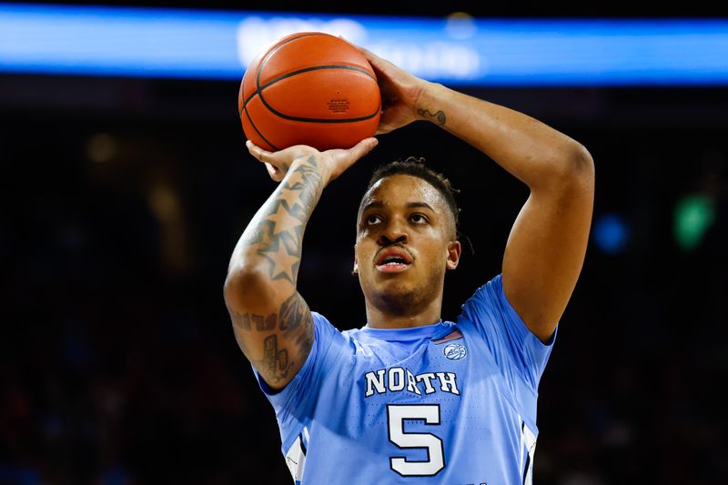 Feb 19, 2023; Raleigh, North Carolina, USA; North Carolina Tar Heels forward Armando Bacot (5) shoots a free throw during the second half of the game against North Carolina State Wolfpack at PNC Arena. Mandatory Credit: Jaylynn Nash-USA TODAY Sports