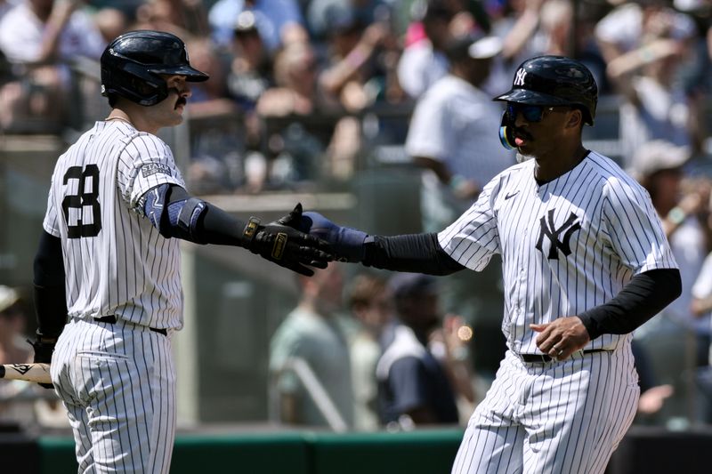 Aug 10, 2024; Bronx, New York, USA; New York Yankees outfielder Trent Grisham (12) is greeted at home plate after scoring on a RBI by New York Yankees outfielder Aaron Judge (not pictured) during the fourth inning against the Texas Rangers at Yankee Stadium. Mandatory Credit: John Jones-USA TODAY Sports