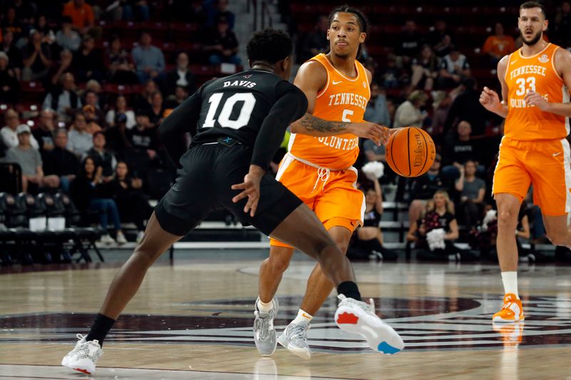 Jan 17, 2023; Starkville, Mississippi, USA; Tennessee Volunteers guard Zakai Zeigler (5) dribbles as Mississippi State Bulldogs guard Dashawn Davis (10) defends during the first half at Humphrey Coliseum. Mandatory Credit: Petre Thomas-USA TODAY Sports