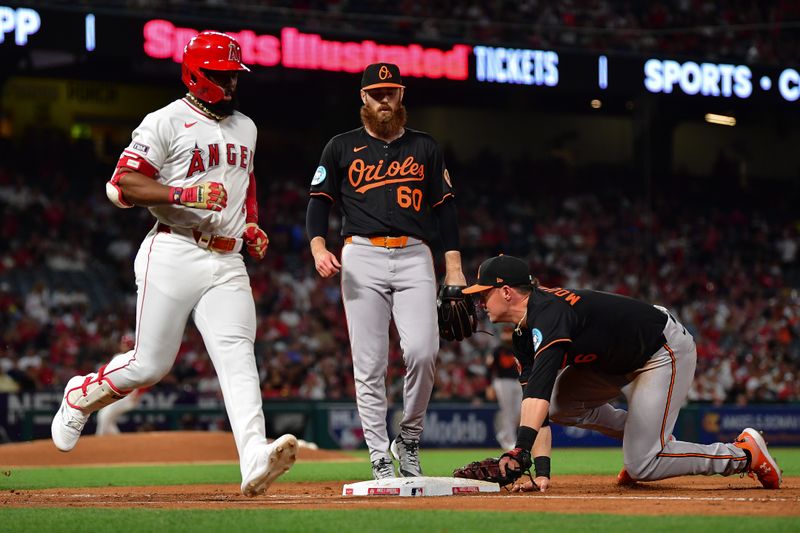 May 10, 2025; Anaheim, California, USA; Baltimore Orioles first baseman Ryan Mountcastle (6) tags first for the out against Los Angeles Angels second baseman Luis Rengifo (2) during the fifth inning at Angel Stadium. Mandatory Credit: Gary A. Vasquez-Imagn Images