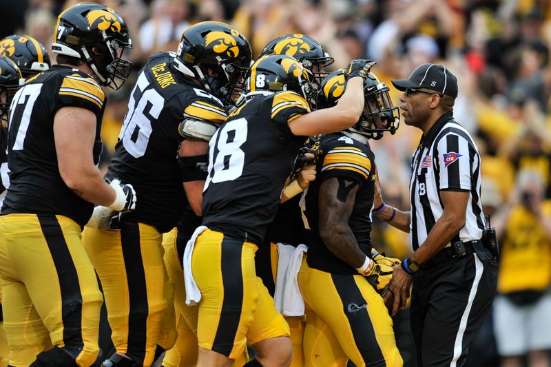 Sep 10, 2022; Iowa City, Iowa, USA; Iowa Hawkeyes running back Leshon Williams (far right) reacts with wide receiver Alec Wick (18) and teammates after scoring on a 9 yard touchdown run during the first quarter against the Iowa State Cyclones at Kinnick Stadium. Mandatory Credit: Jeffrey Becker-USA TODAY Sports