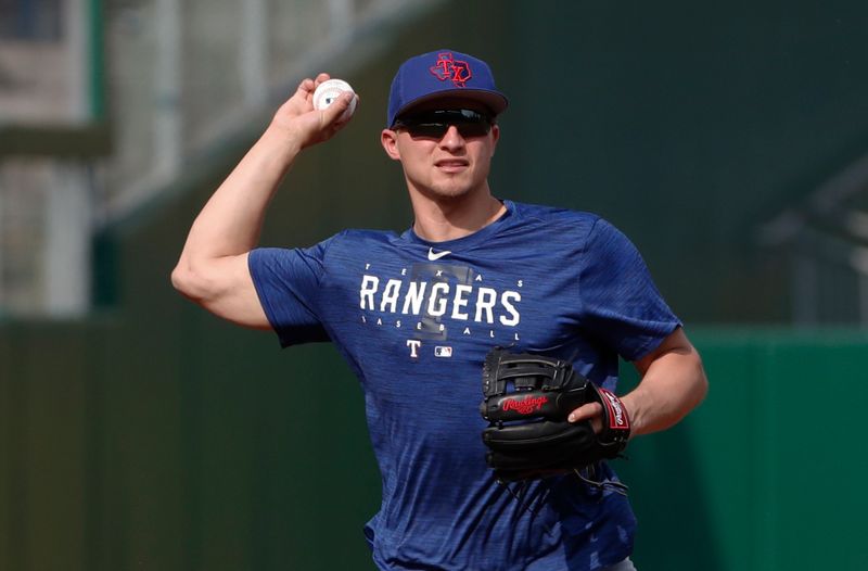 May 22, 2023; Pittsburgh, Pennsylvania, USA;  Texas Rangers shortstop Corey Seager (5) warms before a game against the Pittsburgh Pirates at PNC Park. Mandatory Credit: Charles LeClaire-USA TODAY Sports