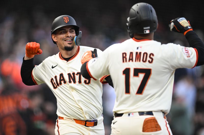 May 1, 2025; San Francisco, California, USA; San Francisco Giants left fielder Heliot Ramos (17) celebrates his solo home run with shortstop Willy Adames (2) against the Colorado Rockies in the first inning at Oracle Park. Mandatory Credit: Eakin Howard-Imagn Images