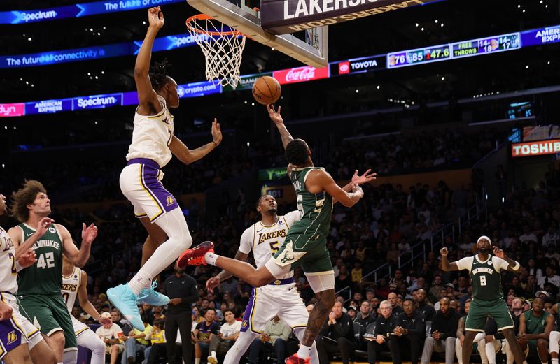LOS ANGELES, CALIFORNIA - OCTOBER 15: Cameron Payne #15 of the Milwaukee Bucks drives to the basket against Maxwell Lewis #21 of the Los Angeles Lakers during the second half of a preseason basketball game at Crypto.com Arena on October 15, 2023 in Los Angeles, California. NOTE TO USER: User expressly acknowledges and agrees that, by downloading and or using this photograph, User is consenting to the terms and conditions of the Getty Images License Agreement. (Photo by Kevork Djansezian/Getty Images)