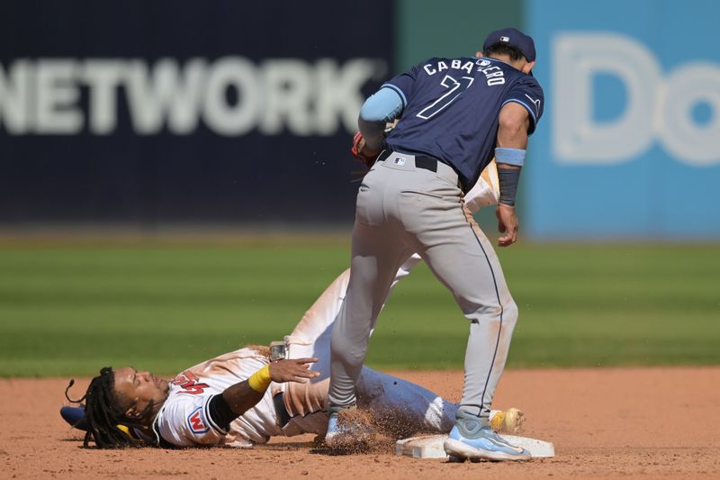 Sep 15, 2024; Cleveland, Ohio, USA; Tampa Bay Rays shortstop Jose Caballero (7) tags out Cleveland Guardians designated hitter Jose Ramirez (11) while stealing during the fifth inning at Progressive Field. Mandatory Credit: Ken Blaze-Imagn Images
