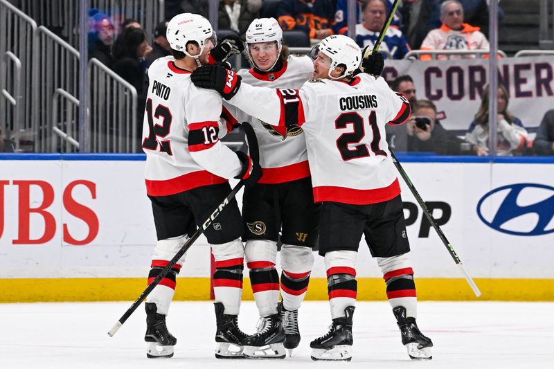 Jan 14, 2025; Elmont, New York, USA;  Ottawa Senators right wing Adam Gaudette (81) celebrates his goal against the New York Islanders with Ottawa Senators center Nick Cousins (21) and Ottawa Senators center Shane Pinto (12) during the second period at UBS Arena. Mandatory Credit: Dennis Schneidler-Imagn Images
