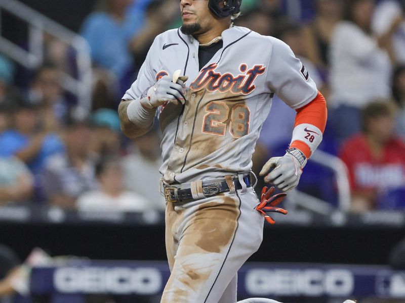 Jul 30, 2023; Miami, Florida, USA; Detroit Tigers shortstop Javier Baez (28) scores after a two-run double by designated hitter Miguel Cabrera (not pictured) during the third inning at loanDepot Park. Mandatory Credit: Sam Navarro-USA TODAY Sports