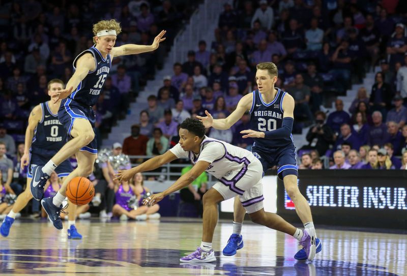 Feb 24, 2024; Manhattan, Kansas, USA; Kansas State Wildcats guard Tylor Perry (2) passes the ball away from Brigham Young Cougars guards Spencer Johnson (20) and Richie Saunders (15) during the second half at Bramlage Coliseum. Mandatory Credit: Scott Sewell-USA TODAY Sports