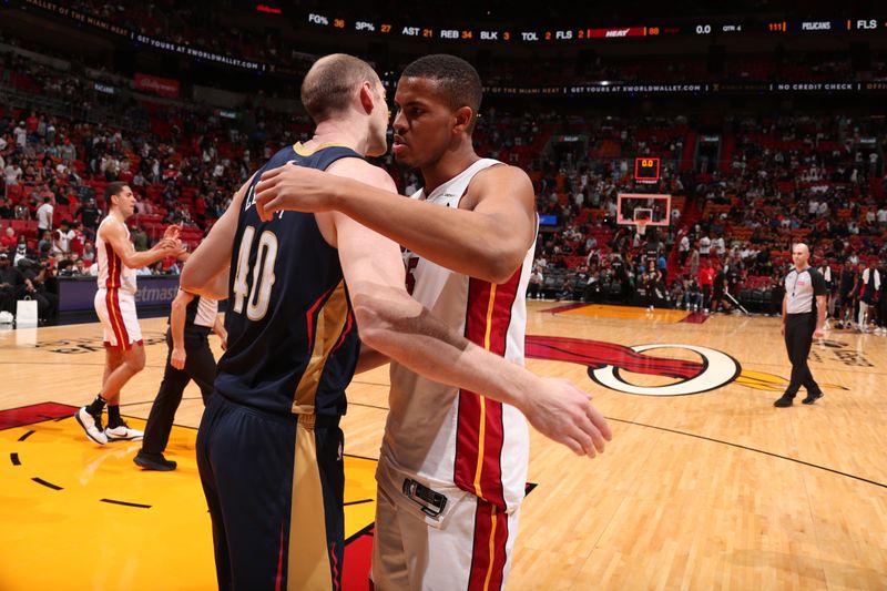 MIAMI, FL - MARCH 22: Orlando Robinson #25 of the Miami Heat embraces Cody Zeller #40 of the New Orleans Pelicans after the game on March 22, 2024 at Kaseya Center in Miami, Florida. NOTE TO USER: User expressly acknowledges and agrees that, by downloading and or using this Photograph, user is consenting to the terms and conditions of the Getty Images License Agreement. Mandatory Copyright Notice: Copyright 2024 NBAE (Photo by Issac Baldizon/NBAE via Getty Images)