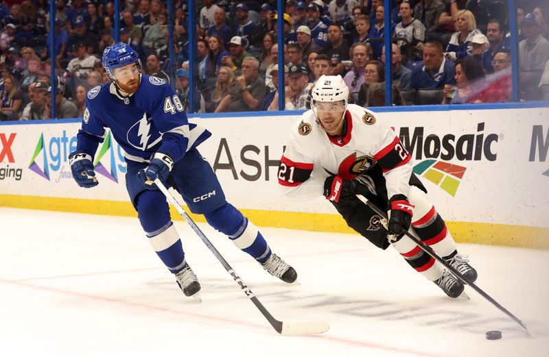 Apr 11, 2024; Tampa, Florida, USA; Tampa Bay Lightning defenseman Nick Perbix (48) defends Ottawa Senators right wing Mathieu Joseph (21) during overtime at Amalie Arena. Mandatory Credit: Kim Klement Neitzel-USA TODAY Sports