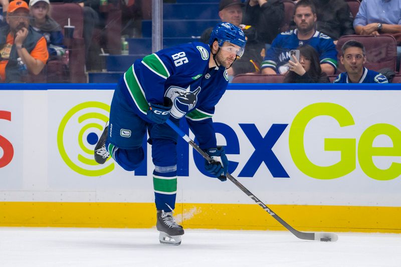 Sep 24, 2024; Vancouver, British Columbia, CAN; Vancouver Canucks defenseman Christian Wolanin (86) shoots against the Seattle Kraken during the third period at Rogers Arena. Mandatory Credit: Bob Frid-Imagn Images