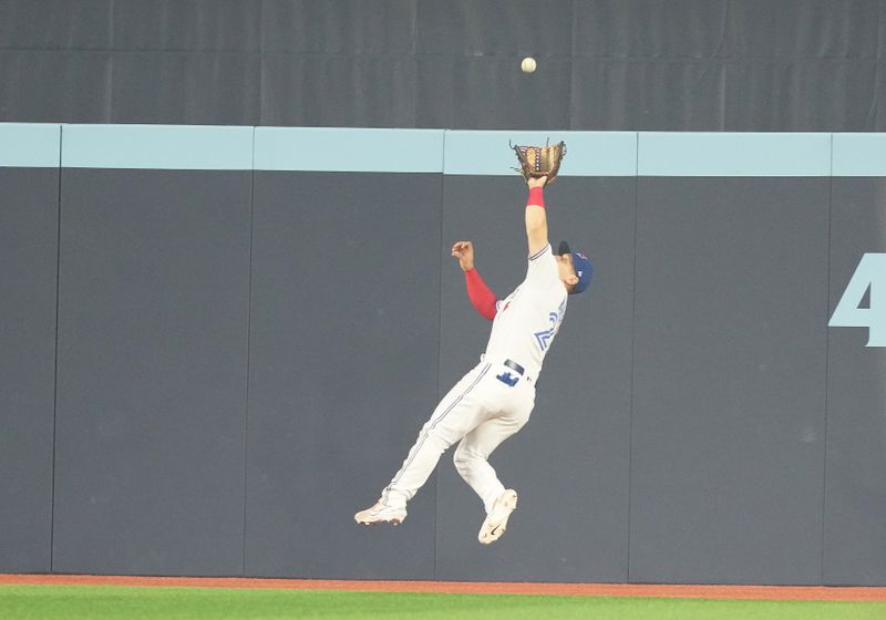 Jun 29, 2023; Toronto, Ontario, CAN; Toronto Blue Jays center fielder Daulton Varsho (25) catches a fly ball against the San Francisco Giants during the eighth inning at Rogers Centre. Mandatory Credit: Nick Turchiaro-USA TODAY Sports