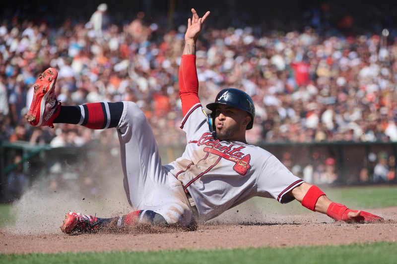 Aug 26, 2023; San Francisco, California, USA; Atlanta Braves outfielder Eddie Rosario (8) slides into home to score a run against the San Francisco Giants during the eighth inning at Oracle Park. Mandatory Credit: Robert Edwards-USA TODAY Sports
