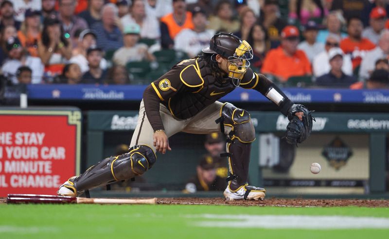 Sep 10, 2023; Houston, Texas, USA; San Diego Padres catcher Luis Campusano (12) commits an error on a play during the sixth inning against the Houston Astros at Minute Maid Park. Mandatory Credit: Troy Taormina-USA TODAY Sports