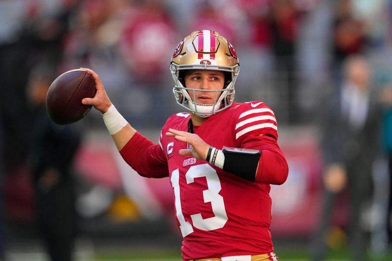 San Francisco 49ers quarterback Brock Purdy warms up before an NFL football game against the Arizona Cardinals Sunday, Dec. 17, 2023, in Glendale, Ariz. (AP Photo/Matt York)