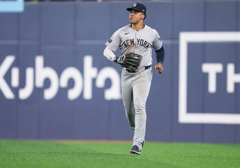 Jun 30, 2024; Toronto, Ontario, CAN; New York Yankees right fielder Juan Soto (22) runs back to the dugout against the Toronto Blue Jays at the end of the eighth inning at Rogers Centre. Mandatory Credit: Nick Turchiaro-USA TODAY Sports