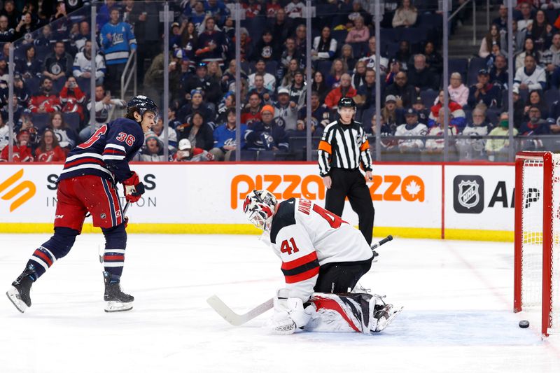 Apr 2, 2023; Winnipeg, Manitoba, CAN; Winnipeg Jets center Morgan Barron (36) scores on a penalty shot against New Jersey Devils goaltender Vitek Vanecek (41) in the second period at Canada Life Centre. Mandatory Credit: James Carey Lauder-USA TODAY Sports