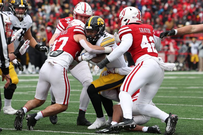 Nov 24, 2023; Lincoln, Nebraska, USA; Nebraska Cornhuskers defensive back Phalen Sanford (37) tackles Iowa Hawkeyes running back Kaleb Johnson (2) at Memorial Stadium. Mandatory Credit: Reese Strickland-USA TODAY Sports