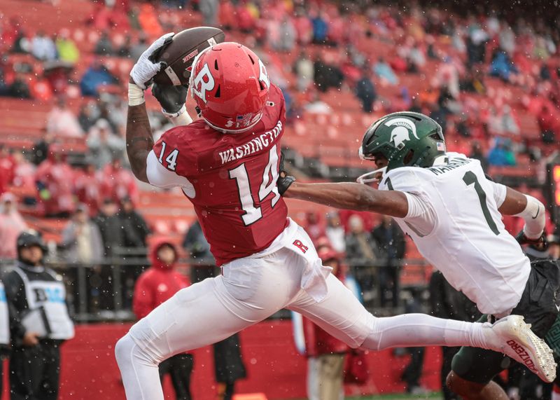 Oct 14, 2023; Piscataway, New Jersey, USA; Rutgers Scarlet Knights wide receiver Isaiah Washington (14) catches a touchdown pass as Michigan State Spartans defensive back Jaden Mangham (1) defends during the second half at SHI Stadium. Mandatory Credit: Vincent Carchietta-USA TODAY Sports