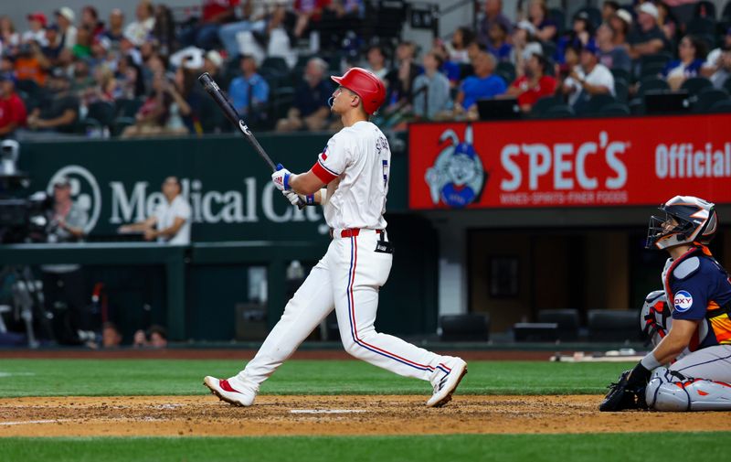 Aug 6, 2024; Arlington, Texas, USA; Texas Rangers shortstop Corey Seager (5) hits a two-run home run during the ninth inning against the Houston Astros at Globe Life Field. Mandatory Credit: Kevin Jairaj-USA TODAY Sports