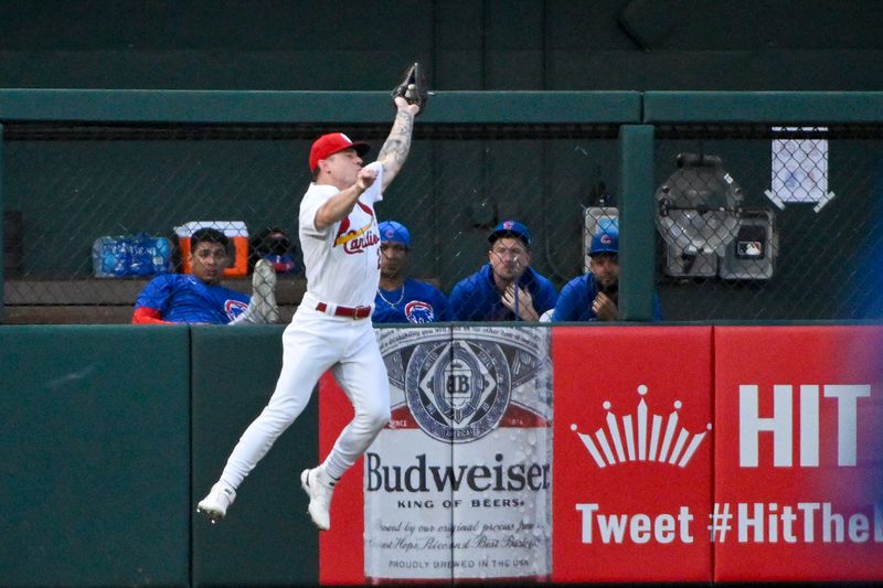 Jul 28, 2023; St. Louis, Missouri, USA;  St. Louis Cardinals left fielder Tyler O'Neill (27) leaps at the wall and catches a fly ball against the Chicago Cubs during the second inning at Busch Stadium. Mandatory Credit: Jeff Curry-USA TODAY Sports