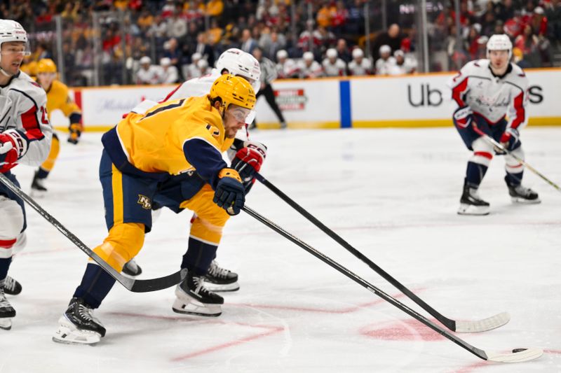 Jan 11, 2026; Nashville, Tennessee, USA;  Nashville Predators center Tyson Jost (17) skates with the puck against the Washington Capitals during the third period at Bridgestone Arena. Mandatory Credit: Steve Roberts-Imagn Images