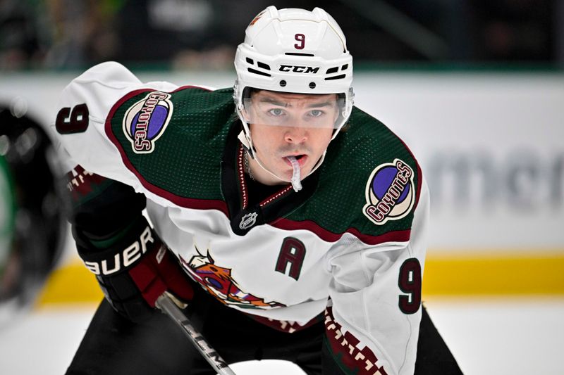 Nov 14, 2023; Dallas, Texas, USA; Arizona Coyotes right wing Clayton Keller (9) waits for the face-off against the Dallas Stars during the first period at the American Airlines Center. Mandatory Credit: Jerome Miron-USA TODAY Sports