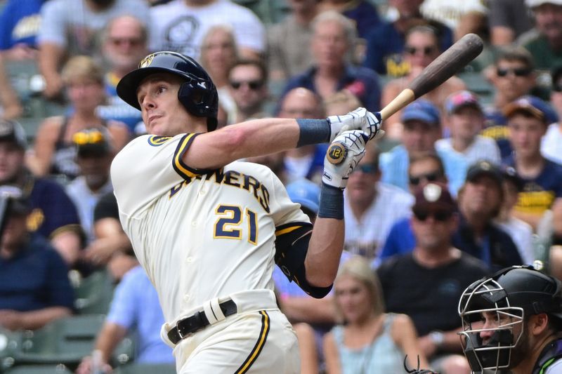 Aug 9, 2023; Milwaukee, Wisconsin, USA;  Milwaukee Brewers first baseman Mark Canha (21) hits a double to drive in a run in the tenth inning against the Colorado Rockies at American Family Field. Mandatory Credit: Benny Sieu-USA TODAY Sports