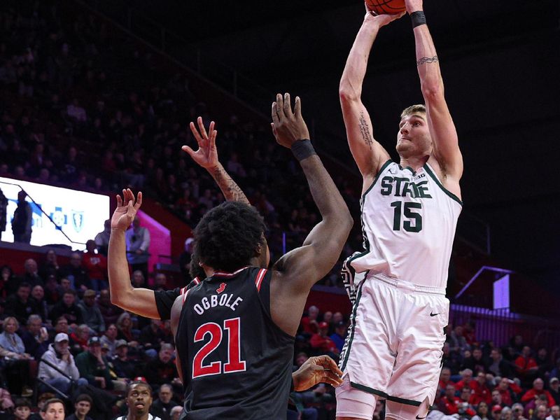 Jan 27, 2026; Piscataway, New Jersey, USA; Michigan State Spartans center Carson Cooper (15) shoots the ball in front of Rutgers Scarlet Knights center Emmanuel Ogbole (21) during the first half at Jersey Mike's Arena. Mandatory Credit: Vincent Carchietta-Imagn Images