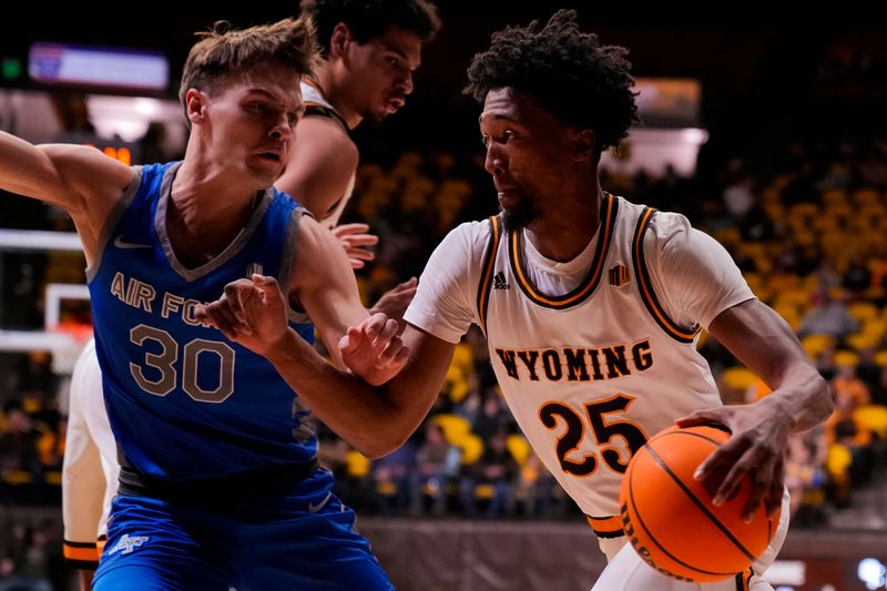 Feb 17, 2023; Laramie, Wyoming, USA; Wyoming Cowboys forward Jeremiah Oden (25) drives against the Air Force Falcons guard Camden Vander Zwaag (30) during the first half at Arena-Auditorium. Mandatory Credit: Troy Babbitt-USA TODAY Sports