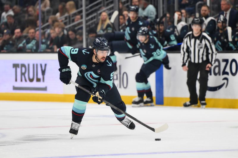 Jan 23, 2025; Seattle, Washington, USA; Seattle Kraken center Chandler Stephenson (9) advances the puck against the Washington Capitals during the first period at Climate Pledge Arena. Mandatory Credit: Steven Bisig-Imagn Images