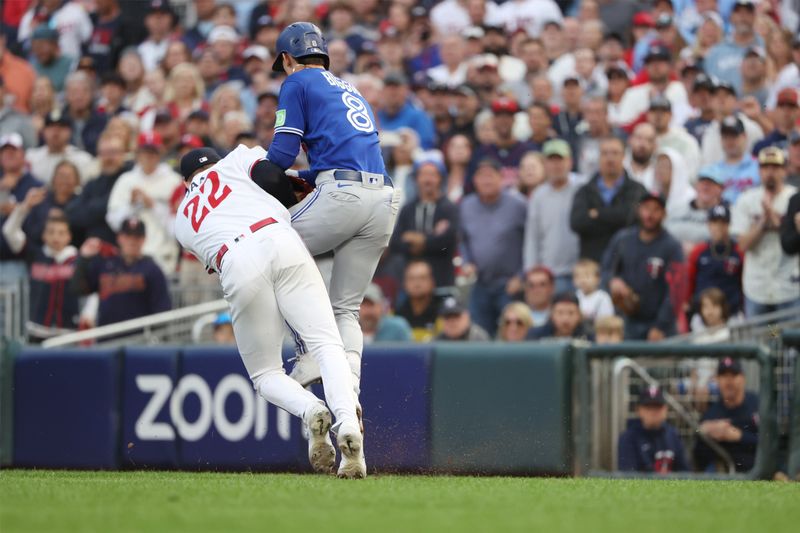 Oct 4, 2023; Minneapolis, Minnesota, USA; Minnesota Twins relief pitcher Griffin Jax (22) tags out Toronto Blue Jays second baseman Cavan Biggio (8) in the eighth inning  during game two of the Wildcard series for the 2023 MLB playoffs at Target Field. Mandatory Credit: Jesse Johnson-USA TODAY Sports