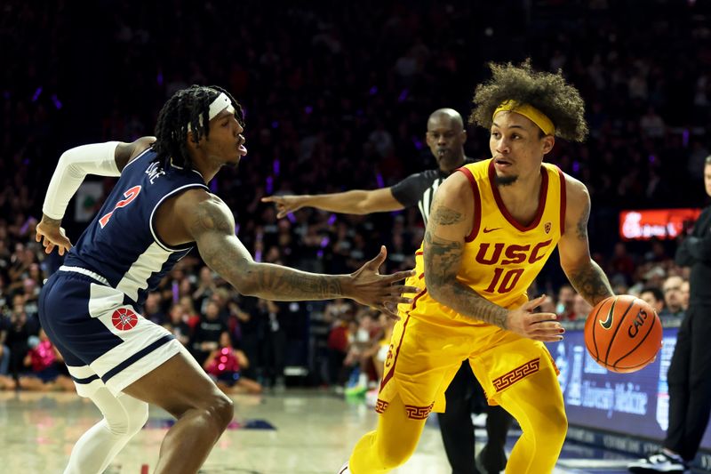 Jan 17, 2024; Tucson, Arizona, USA; USC Trojans forward DJ Rodman (10) drives to the net against Arizona Wildcats guard Caleb Love (2) during the first half at McKale Center. Mandatory Credit: Zachary BonDurant-USA TODAY Sports