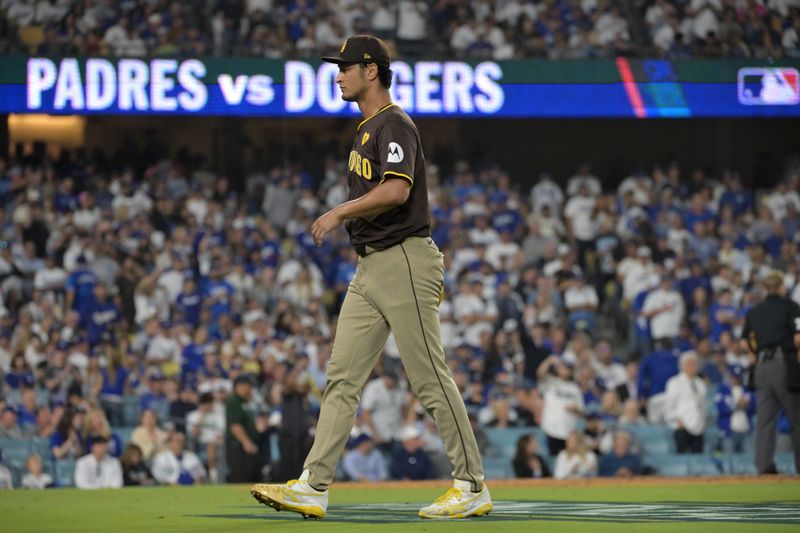 Oct 11, 2024; Los Angeles, California, USA; San Diego Padres pitcher Yu Darvish (11) reacts after a solo home run by Los Angeles Dodgers outfielder Teoscar Hernandez (not pictured) in the seventh inning during game five of the NLDS for the 2024 MLB Playoffs at Dodger Stadium. Mandatory Credit: Jayne Kamin-Oncea-Imagn Images