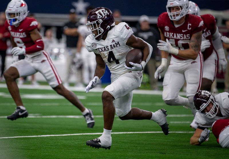 Sep 30, 2023; Arlington, Texas, USA; Texas A&M Aggies running back Amari Daniels (4) runs with the ball against the Arkansas Razorbacks during the second half at AT&T Stadium. Mandatory Credit: Jerome Miron-USA TODAY Sports