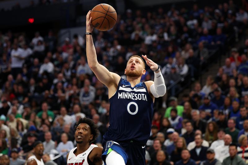 MINNEAPOLIS, MINNESOTA - NOVEMBER 10: Donte DiVincenzo #0 of the Minnesota Timberwolves goes up for a shot against the Miami Heat in the first quarter at Target Center on November 10, 2024 in Minneapolis, Minnesota. NOTE TO USER: User expressly acknowledges and agrees that, by downloading and or using this photograph, User is consenting to the terms and conditions of the Getty Images License Agreement. (Photo by David Berding/Getty Images)