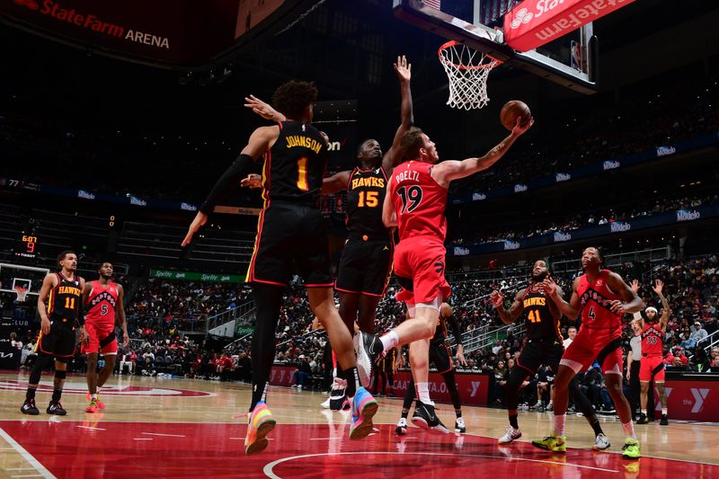 ATLANTA, GA - February 23:  Jakob Poeltl #19 of the Toronto Raptors drives to the basket during the game against the Atlanta Hawks on February 23, 2024 at State Farm Arena in Atlanta, Georgia.  NOTE TO USER: User expressly acknowledges and agrees that, by downloading and/or using this Photograph, user is consenting to the terms and conditions of the Getty Images License Agreement. Mandatory Copyright Notice: Copyright 2024 NBAE (Photo by Scott Cunningham/NBAE via Getty Images)