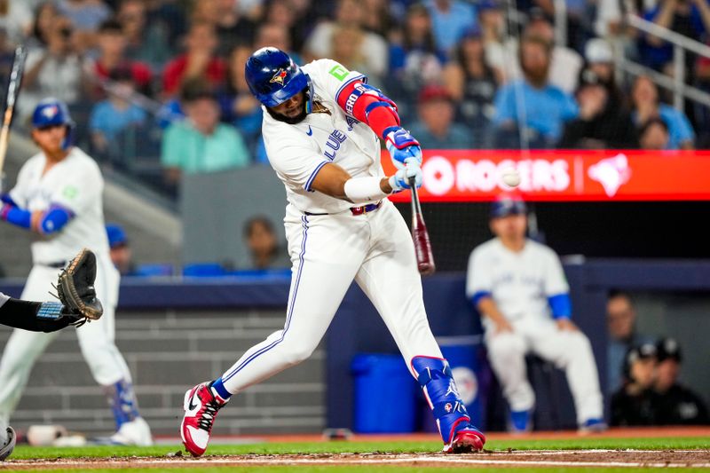 Jun 29, 2024; Toronto, Ontario, CAN; Toronto Blue Jays first base Vladimir Guerrero Jr. (27) hits a home run against the New York Yankees during the first inning at Rogers Centre. Mandatory Credit: Kevin Sousa-USA TODAY Sports