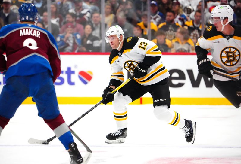 Oct 16, 2024; Denver, Colorado, USA; Boston Bruins center Charlie Coyle (13) skates with the puck during the first period against the Colorado Avalanche at Ball Arena. Mandatory Credit: Ron Chenoy-Imagn Images