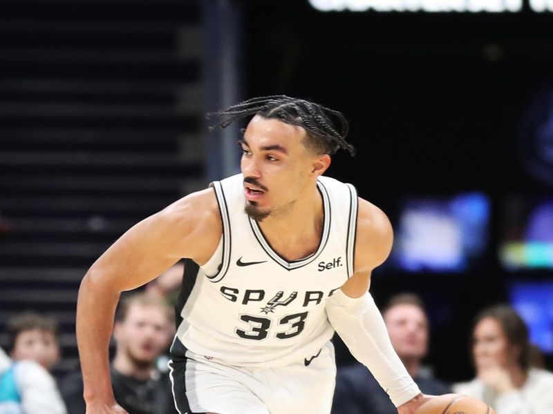 CHARLOTTE, NC - JANUARY 19: Tre Jones #33 of the San Antonio Spurs handles the ball during the game against the Charlotte Hornets on January 19, 2024 at Spectrum Center in Charlotte, North Carolina. NOTE TO USER: User expressly acknowledges and agrees that, by downloading and or using this photograph, User is consenting to the terms and conditions of the Getty Images License Agreement.  Mandatory Copyright Notice:  Copyright 2024 NBAE (Photo by Brock Williams-Smith/NBAE via Getty Images)