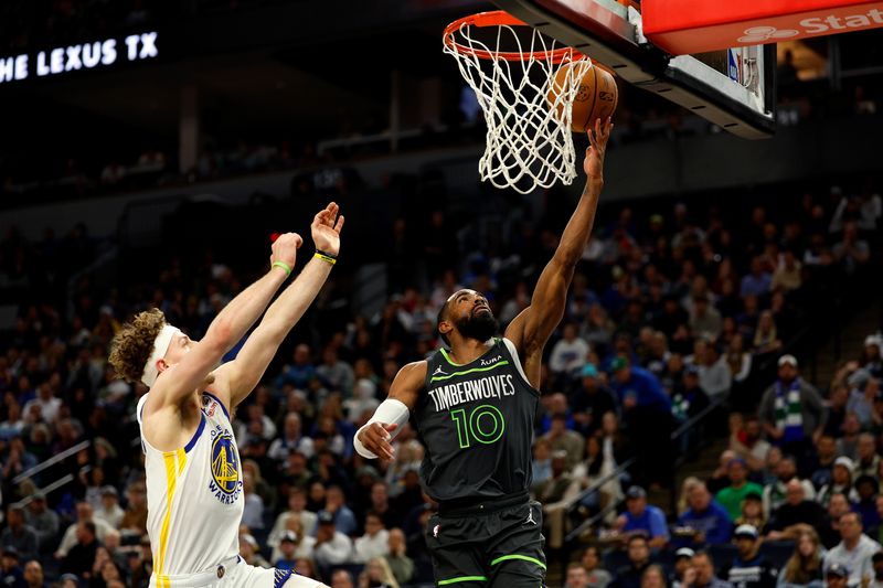 MINNEAPOLIS, MINNESOTA - MARCH 24: Mike Conley #10 of the Minnesota Timberwolves goes up for a shot past Brandin Podziemski #2 of the Golden State Warriors in the third quarter at Target Center on March 24, 2024 in Minneapolis, Minnesota. The Timberwolves defeated the Warriors 114-110. NOTE TO USER: User expressly acknowledges and agrees that, by downloading and or using this photograph, User is consenting to the terms and conditions of the Getty Images License Agreement. (Photo by David Berding/Getty Images)