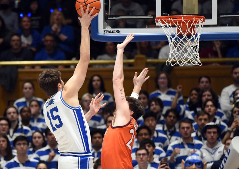 Feb 25, 2023; Durham, North Carolina, USA; Duke Blue Devils center Ryan Young (15) shoots over Virginia Tech Hokies forward Grant Basile (21) during the first half at Cameron Indoor Stadium. Mandatory Credit: Rob Kinnan-USA TODAY Sports