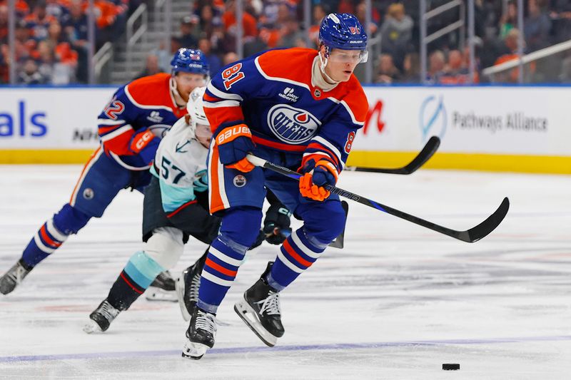 Sep 24, 2025; Edmonton, Alberta, CAN; Seattle Kraken forward Jagger Firkus (57) tries to knock the puck away from Edmonton Oilers forward Josh Samanski (81) during the third period at Rogers Place. Mandatory Credit: Perry Nelson-Imagn Images
