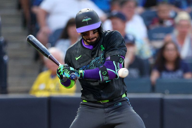 May 27, 2025; Tampa, Florida, USA; Tampa Bay Rays shortstop Jose Caballero (77) is hit by a pitch against the Minnesota Twins in the fourth inning at George M. Steinbrenner Field. Mandatory Credit: Nathan Ray Seebeck-Imagn Images