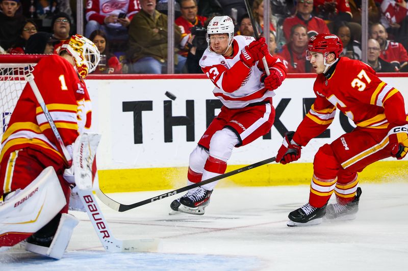 Dec 10, 2025; Calgary, Alberta, CAN; Calgary Flames goaltender Devin Cooley (1) makes a save against Detroit Red Wings left wing Lucas Raymond (23) during the third period at Scotiabank Saddledome. Mandatory Credit: Sergei Belski-Imagn Images