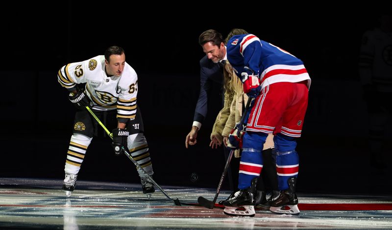 Nov 25, 2023; New York, New York, USA; Former New York Rangers goalie and newly-inducted Hall of Famer Henrik Lundqvist drops a ceremonial first puck alongside Boston Bruins left wing Brad Marchand (63) and New York Rangers defenseman Jacob Trouba (8) before the first period at Madison Square Garden. Mandatory Credit: Danny Wild-USA TODAY Sports