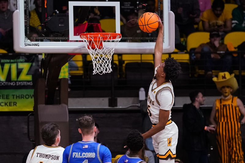 Feb 17, 2023; Laramie, Wyoming, USA; Wyoming Cowboys forward Jeremiah Oden (25) dunks against the Air Force Falcons during the first half at Arena-Auditorium. Mandatory Credit: Troy Babbitt-USA TODAY Sports